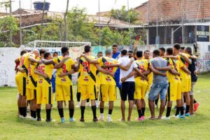 Amateur soccer players huddle on the field, preparing for their match with motivational energy and teamwork.
