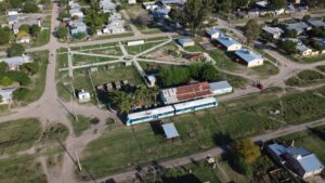 Aerial view of Cote-lai, Chaco, featuring a train and small town layout on a sunny day.